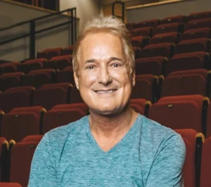 Photo of a smiling man in a theater