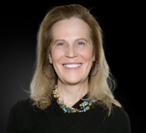 Photo of a smiling woman in front of a black background